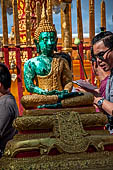 Chiang Mai - Wat Phra That Doi Suthep. The innercourtyard of the temple is filled with Buddha statues and other religious paraphenalia. 